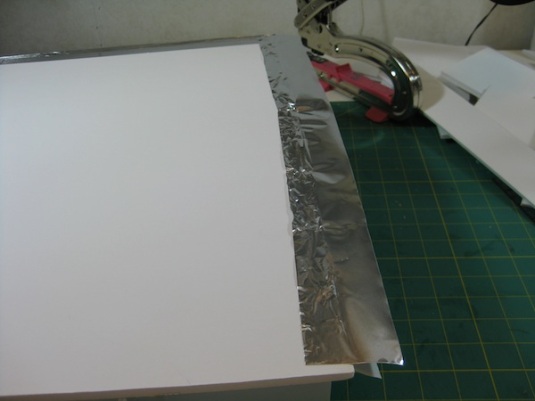 Adhering the top piece.  Peel back only half of the protective paper.